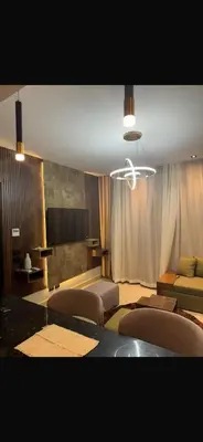 a living room with chairs and a table and a projector at Hurghada in Hurghada