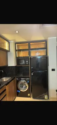 a kitchen with a black refrigerator and a stove at Hurghada in Hurghada