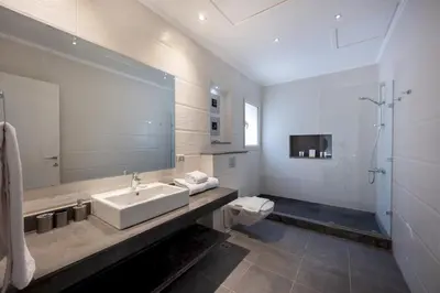 a bathroom with a sink and a toilet and a mirror at VESTA - Soma Bay Residence in Hurghada