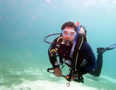a man in a scuba diver in the water at Funnydivers Diving center in Hurghada