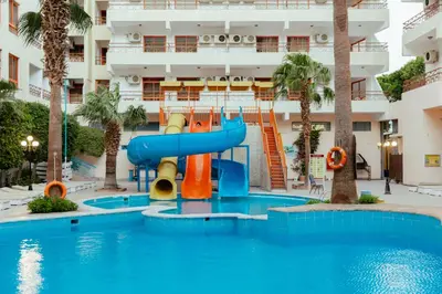 a water slide in a pool in a hotel at Apartment Empire Hotel in Hurghada