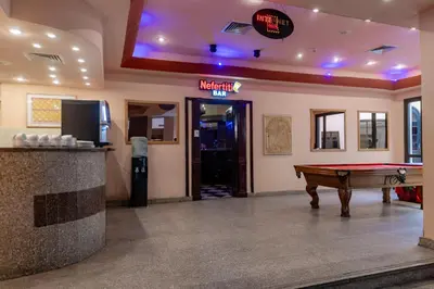 a room with a pool table and a sign that reads night club at Apartment Empire Hotel in Hurghada