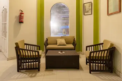 a waiting room with a couch and two chairs at Apartment Empire Hotel in Hurghada