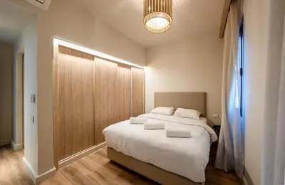a bedroom with a large bed with white sheets at Elegant Fanadir Marina 2BR • Ground Floor in Hurghada