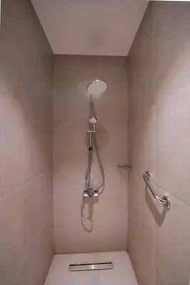 a shower with a shower head in a bathroom at Elegant Fanadir Marina 2BR • Ground Floor in Hurghada