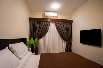 a hotel room with a bed and a television at Nile Crown Luxor in Luxor