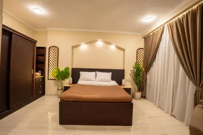 a bedroom with a bed and a large mirror at Nile Crown Luxor in Luxor
