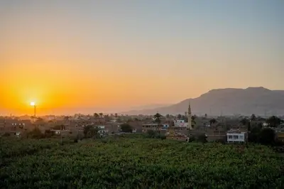 a view of a city at sunset at Nile Crown Luxor in Luxor
