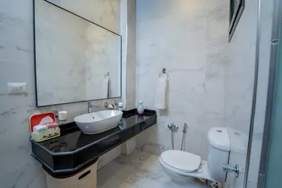 a bathroom with a sink and a toilet and a mirror at Nile Crown Luxor in Luxor