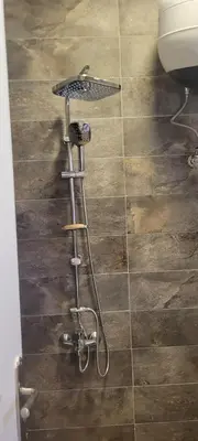 a shower in a bathroom with a wooden floor at Gamela in Hurghada