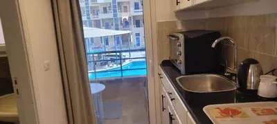 a kitchen with a sink and a view of a pool at Gamela in Hurghada