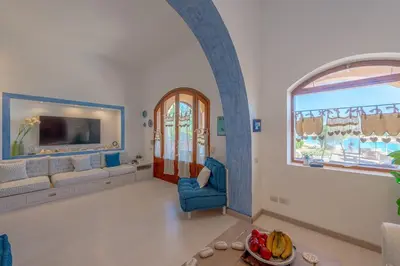 a living room with a couch and a window at Rihanna apartment direct to the sea in Hurghada