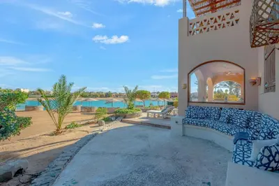 a house with a blue couch on a patio at Rihanna apartment direct to the sea in Hurghada