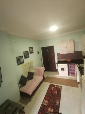 a living room with a couch and a stove at Lotus Stay شاليه مفروش بالغردقة in Hurghada