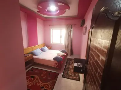 a small bedroom with a bed and a window at Lotus Stay شاليه مفروش بالغردقة in Hurghada