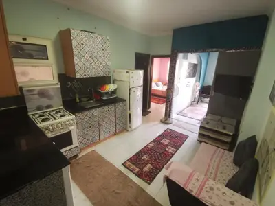 an aerial view of a kitchen with a stove and refrigerator at Lotus Stay شاليه مفروش بالغردقة in Hurghada