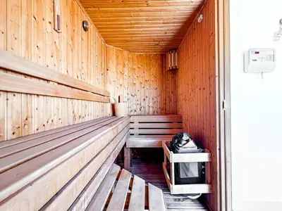 a sauna with a bench and a tv in it at Beachfront Apartment Somabay in Hurghada