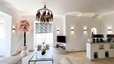 a living room with a chandelier and a couch at Beachfront Apartment Somabay in Hurghada