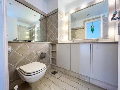 a bathroom with a toilet and a mirror at Beachfront Apartment Somabay in Hurghada