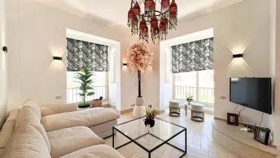 a living room with a couch and a tv at Beachfront Apartment Somabay in Hurghada