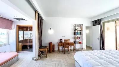 a bedroom with a bed and a dining room with a table at Beachfront Apartment Somabay in Hurghada