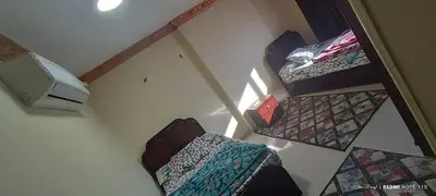 an overhead view of a living room with two chairs and a television at شقة كورنيش النيل 3غرف فيو كامل علي النيل in Aswan