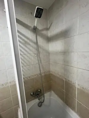 a shower with a shower head in a bathroom at Studio sea view in Hurghada
