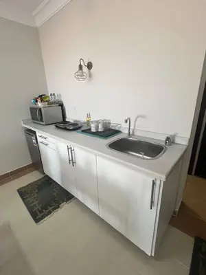 a kitchen with a sink and a microwave at Studio sea view in Hurghada