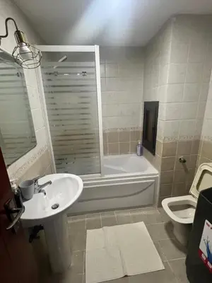 a bathroom with a sink and a tub and a toilet at Studio sea view in Hurghada