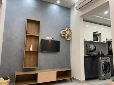 a kitchen with a tv on the wall and a washing machine at Luxury serviced apartments in Hurghada