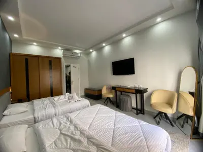 a bedroom with a bed and a desk and a tv at Luxury serviced apartments in Hurghada
