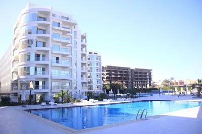 a large apartment building next to a swimming pool at Luxury serviced apartments in Hurghada