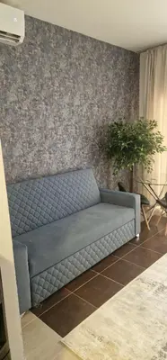 a blue couch in a room with a wall at Blue Dream in Hurghada
