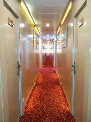 a hallway with a long red carpeted corridor at دهبيه كوين شارلوت in Luxor