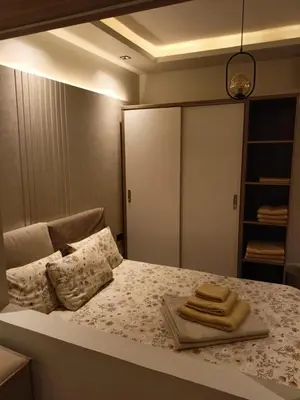 a bedroom with a bed with two towels on it at Palma House in Hurghada