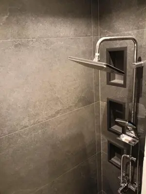 a bathroom with a shower with a shower head at Palma House in Hurghada