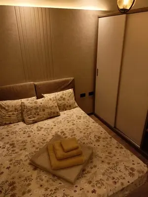 a bed with a tray with two towels on it at Palma House in Hurghada