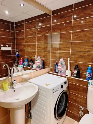 a bathroom with a washing machine and a sink at Florenza Khamsin, Studio i415-B in Hurghada