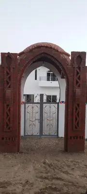 an archway with a gate in front of a building at Villa Saeed in Al Karnak