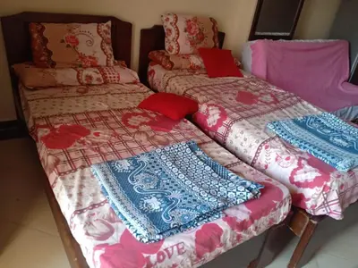 two beds sitting next to each other in a room at Cecelia Resort - Studio chalet in Hurghada