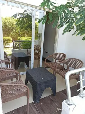 a group of chairs and tables on a porch at Cecelia Resort - Studio chalet in Hurghada
