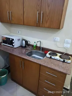 a kitchen counter with a sink and a microwave at Cecelia Resort - Studio chalet in Hurghada