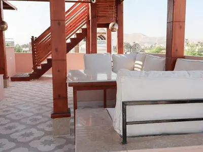 a room with a white couch and a table at Boutique hotel Neferu Stay in Luxor