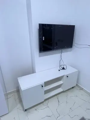 a white dresser with a tv on a wall at الغردقه الشيراتون القديم in Hurghada