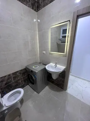 a bathroom with a toilet and a sink and a washing machine at الغردقه الشيراتون القديم in Hurghada