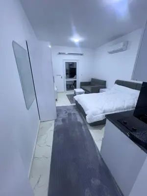a white room with a bed and a kitchen at الغردقه الشيراتون القديم in Hurghada