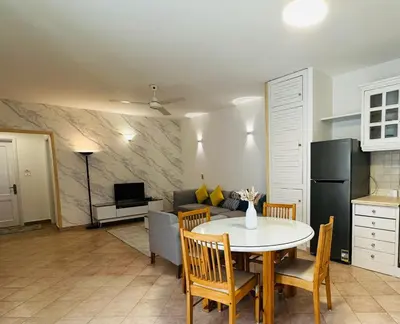 a kitchen and living room with a table and chairs at Enjoy a peaceful stay in Hurghada
