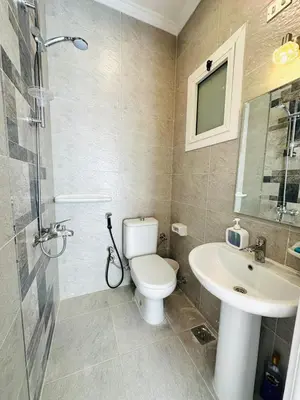 a bathroom with a toilet and a sink at Enjoy a peaceful stay in Hurghada