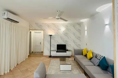 a living room with a couch and a tv at Enjoy a peaceful stay in Hurghada
