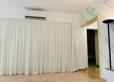 a living room with white curtains and a ceiling at Enjoy a peaceful stay in Hurghada